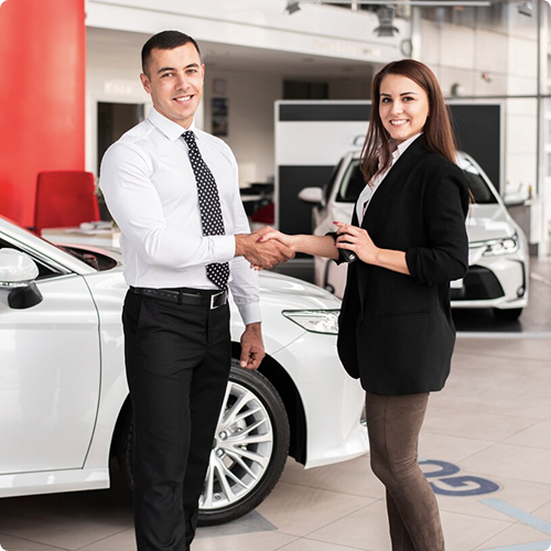 Team members discussing near a car